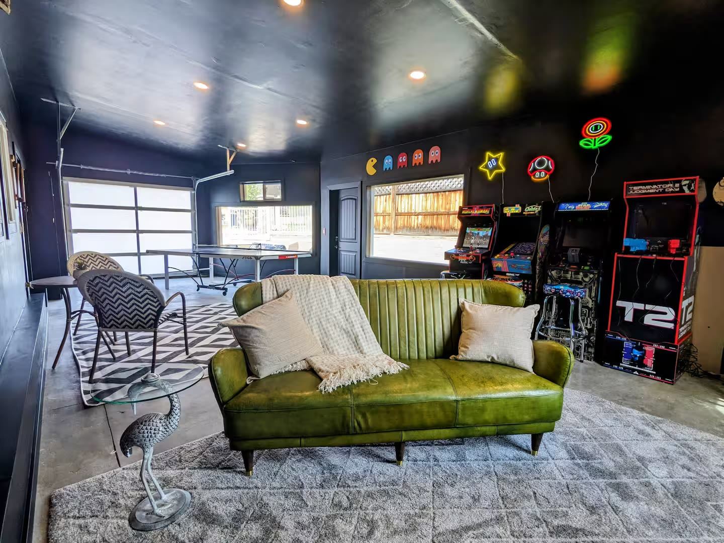 Game room with leather sofa, ping pong and arcade cabinets