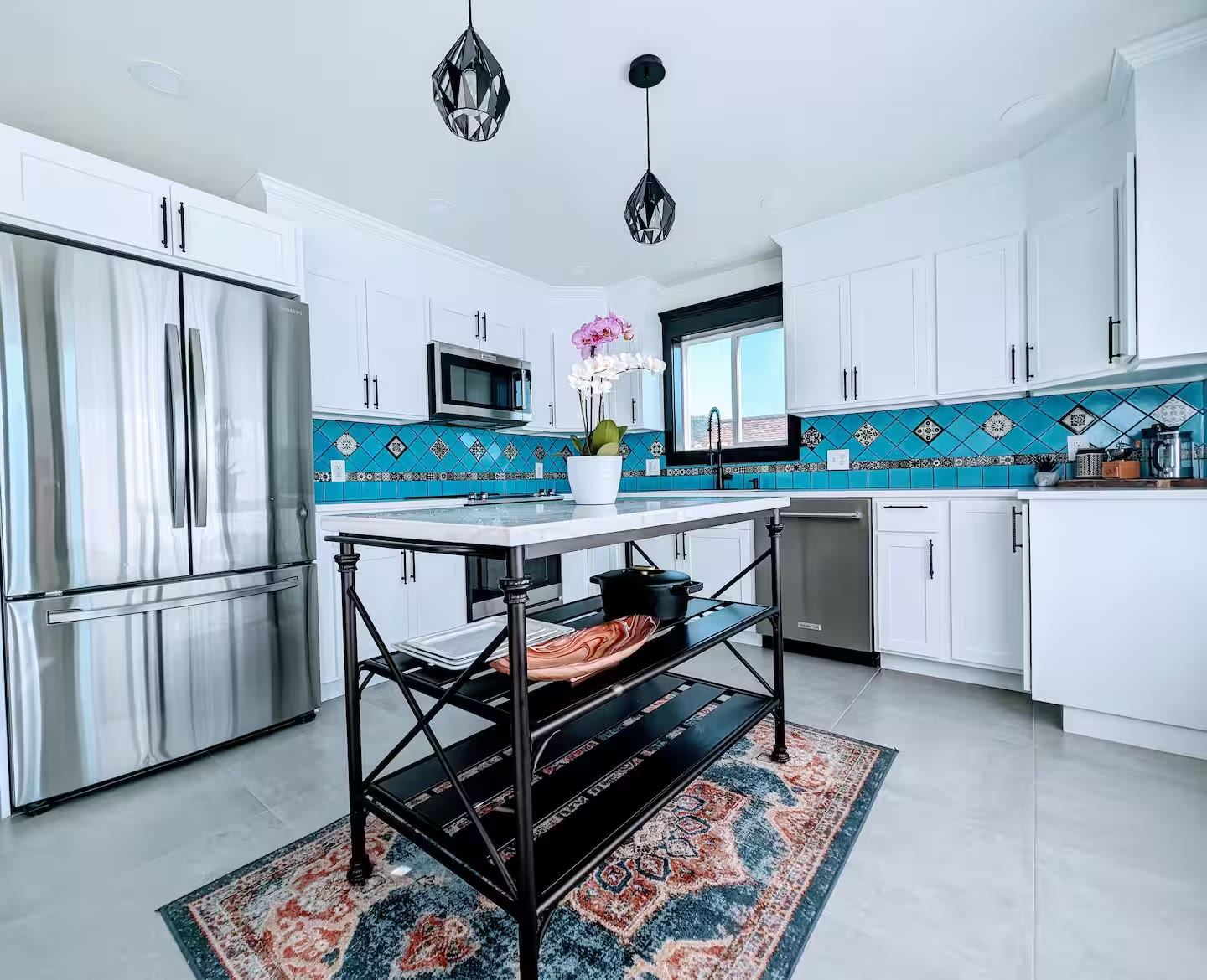 Main kitchen with hand-painted teal Spanish tile backsplash