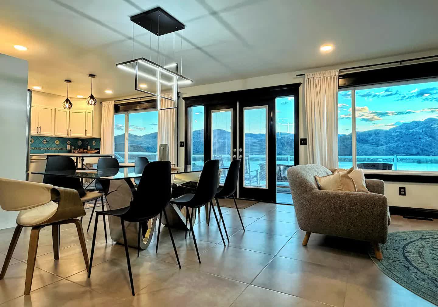 Living and dining space at dusk with panoramic lake view