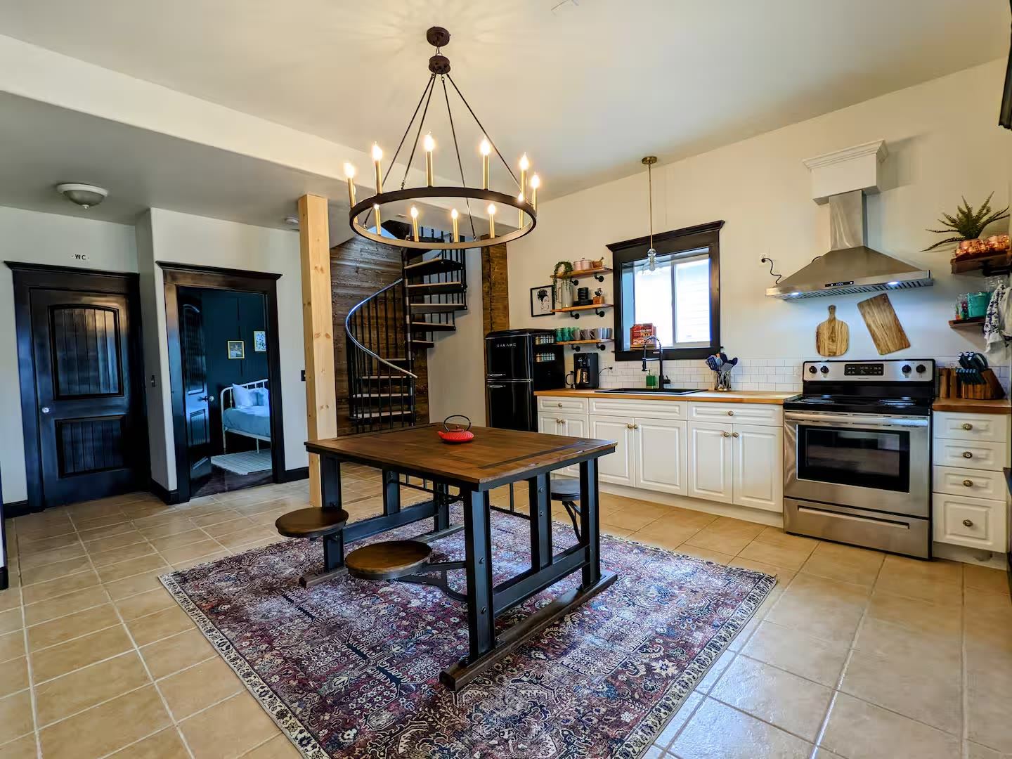 Lower-level kitchen and dining with spiral staircase