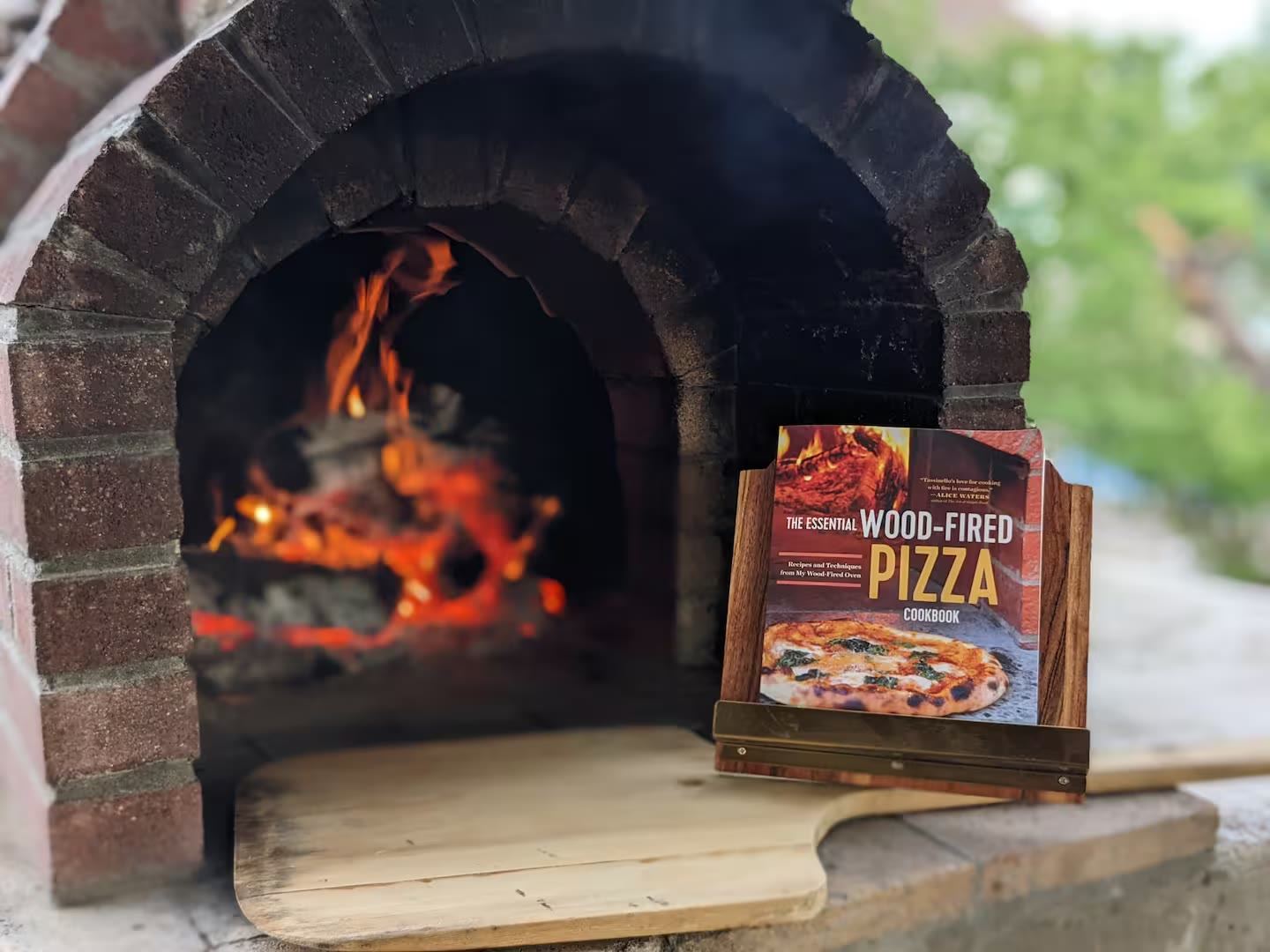 Wood-fired pizza oven with fire burning