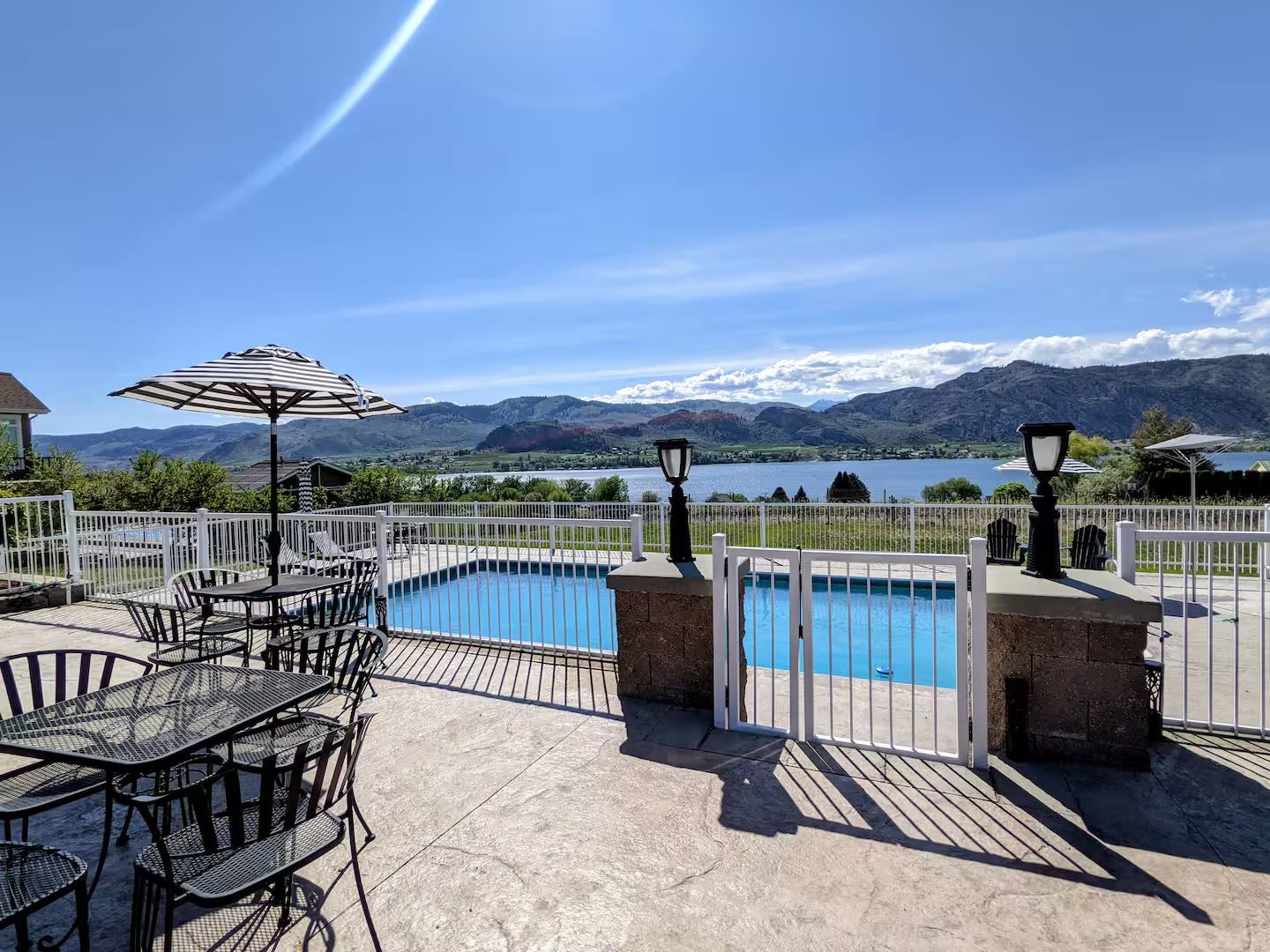Private fenced pool with Lake Osoyoos and the Okanogan hills beyond